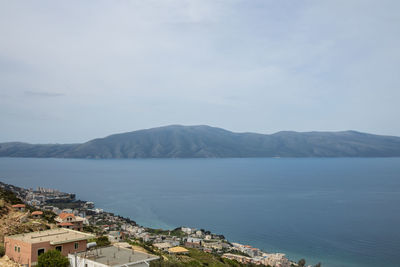 Scenic view of sea and buildings against sky