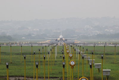 Airplane flying over land against sky