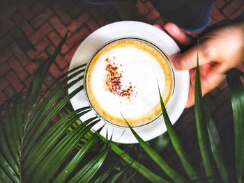 Close-up of hand holding coffee cup