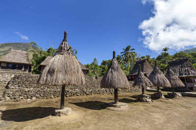 Panoramic view of hut on land against sky