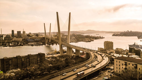 High angle view of highway by cityscape against sky