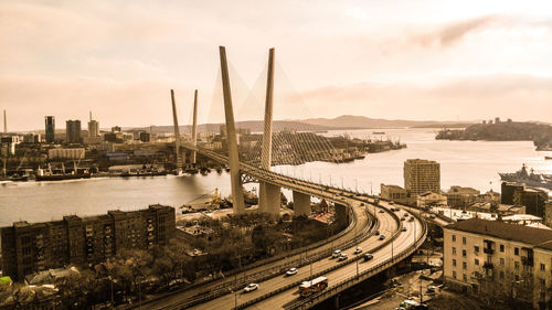 High angle view of highway by cityscape against sky