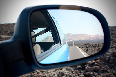 Reflection of car on side-view mirror