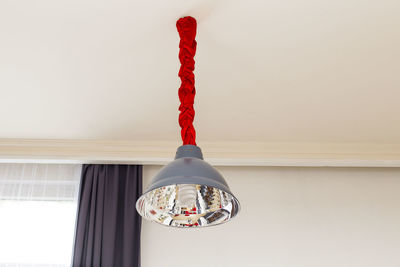 Close-up of electric lamp hanging from ceiling