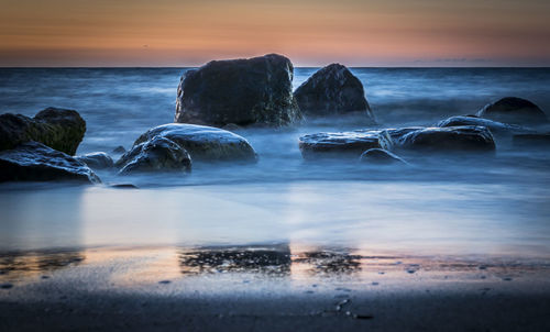 Scenic view of sea at sunset