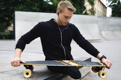 Portrait of young man with skateboard