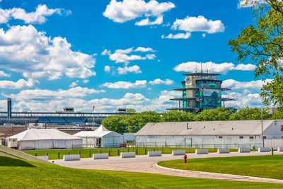 Buildings in city against cloudy sky