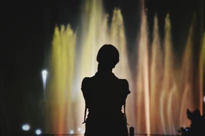 Silhouette boy standing against sky