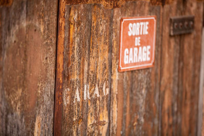 Close-up of sign on wood