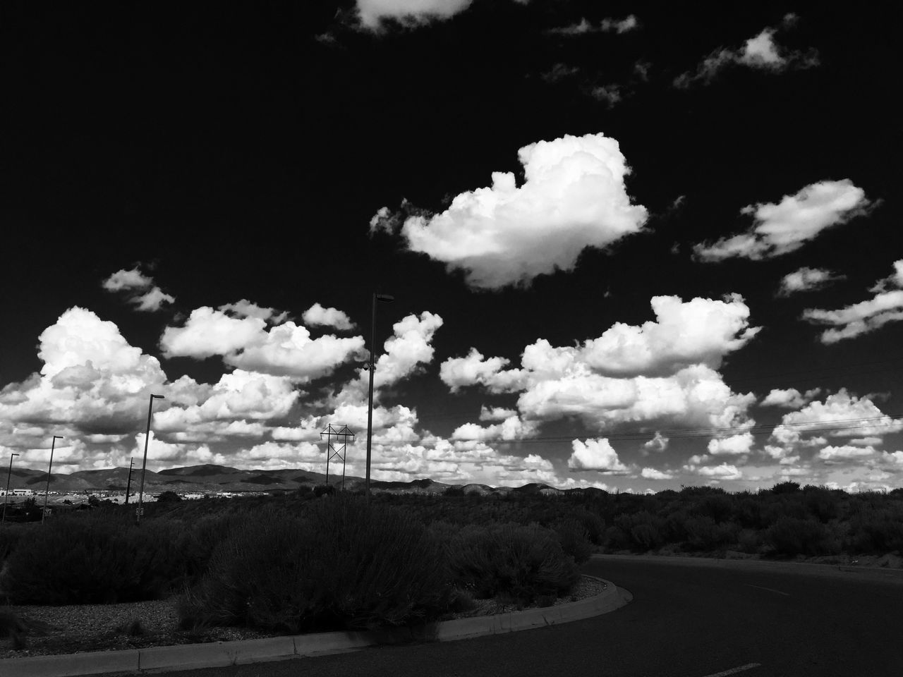 sky, landscape, road, tranquil scene, tranquility, cloud - sky, nature, mountain, scenics, tree, electricity pylon, beauty in nature, field, cloud, cloudy, non-urban scene, day, outdoors, remote, transportation