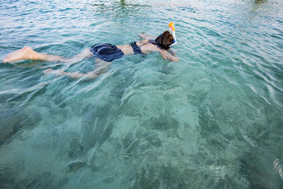 High angle view of woman snorkeling in sea