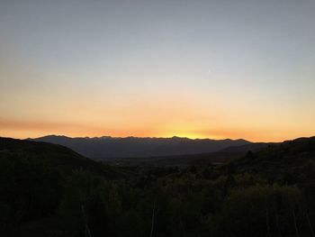 Scenic view of silhouette mountains against sky during sunset