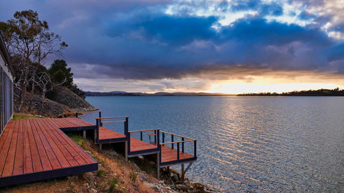 Scenic view of lake against sky at sunset