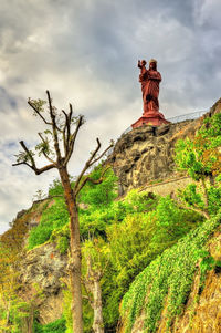 Low angle view of rock formations against sky