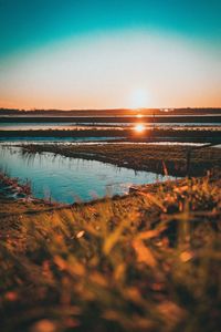 Scenic view of sea against clear sky during sunset