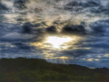 Scenic view of landscape against dramatic sky