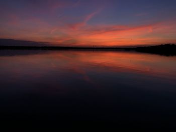 Scenic view of lake against romantic sky at sunset