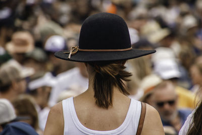 Rear view of woman wearing hat standing outdoors