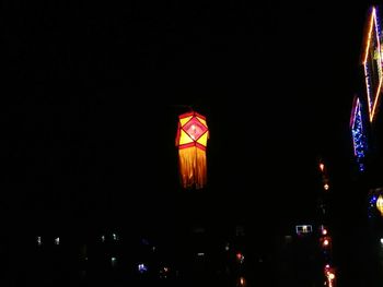 Low angle view of illuminated lights at night