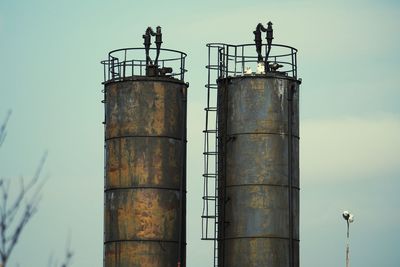 Low angle view of smoke stack against sky