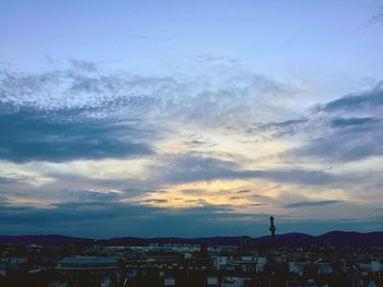 Cityscape against cloudy sky