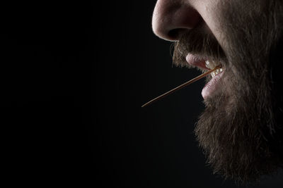 Close-up of man over black background