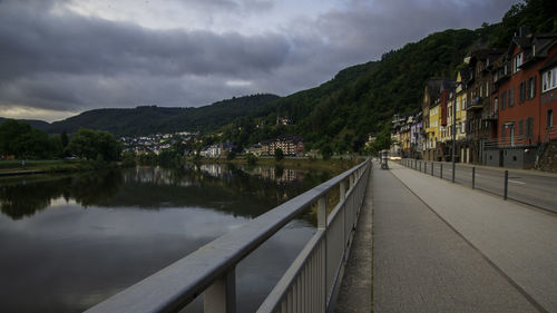 River amidst buildings in city against sky
