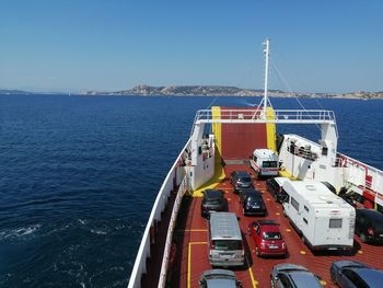 Ship sailing on sea against clear sky