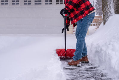 Person standing on snow covered red umbrella
