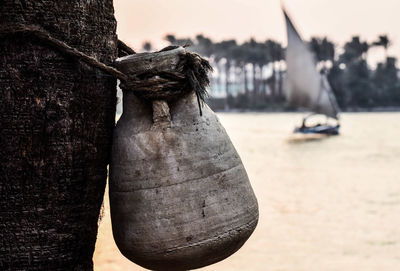 Close-up of fishing net in water against sky