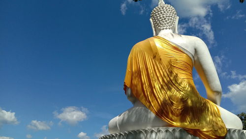 Low angle view of statue against blue sky