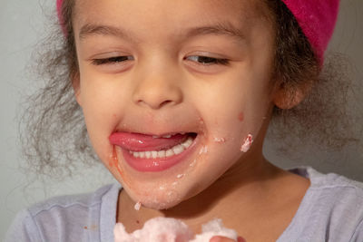 Close-up of cute girl eating cotton candy