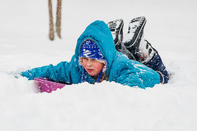 Child sledding on snow