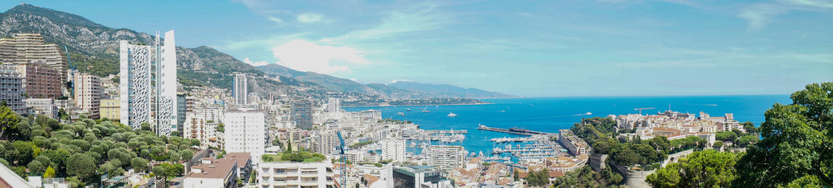 High angle view of city by sea against sky