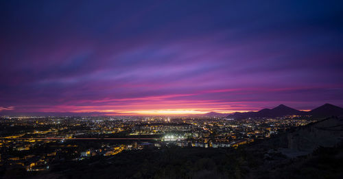 High angle view of illuminated buildings against sky during sunset