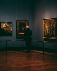 Rear view of man standing against wall