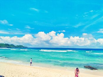 Rear view of man standing at beach