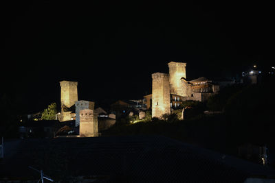 Illuminated buildings against sky at night