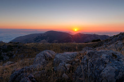 Scenic view of snowcapped mountains against sky during sunset