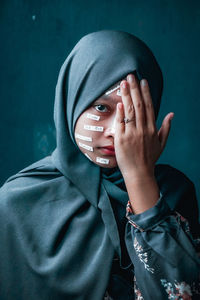 Portrait of person covered covering face