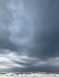 Low angle view of storm clouds over sea