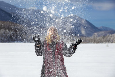 Woman is having winter fun on a snowy, sunny day in lika, croatia