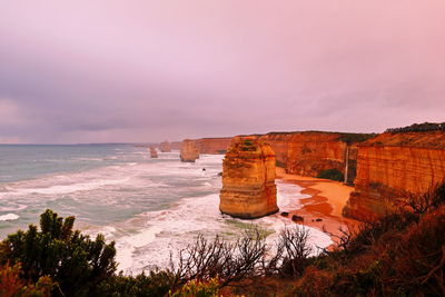 Scenic view of sea against cloudy sky during sunset