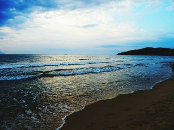 Scenic view of sea against cloudy sky