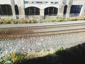 Railroad tracks by buildings in city