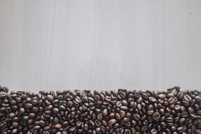 Close-up of coffee beans against wall
