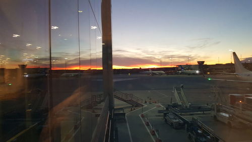 Panoramic view of airport runway against sky during sunset