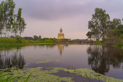 Scenic view of lake by building against sky