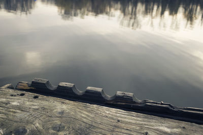 Close-up of wood against lake