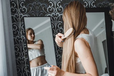 Midsection of woman standing at home